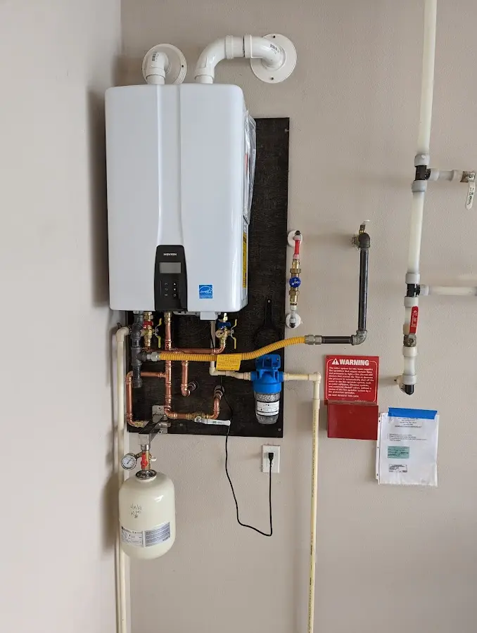 Professional plumber installing copper piping in a Geneva home